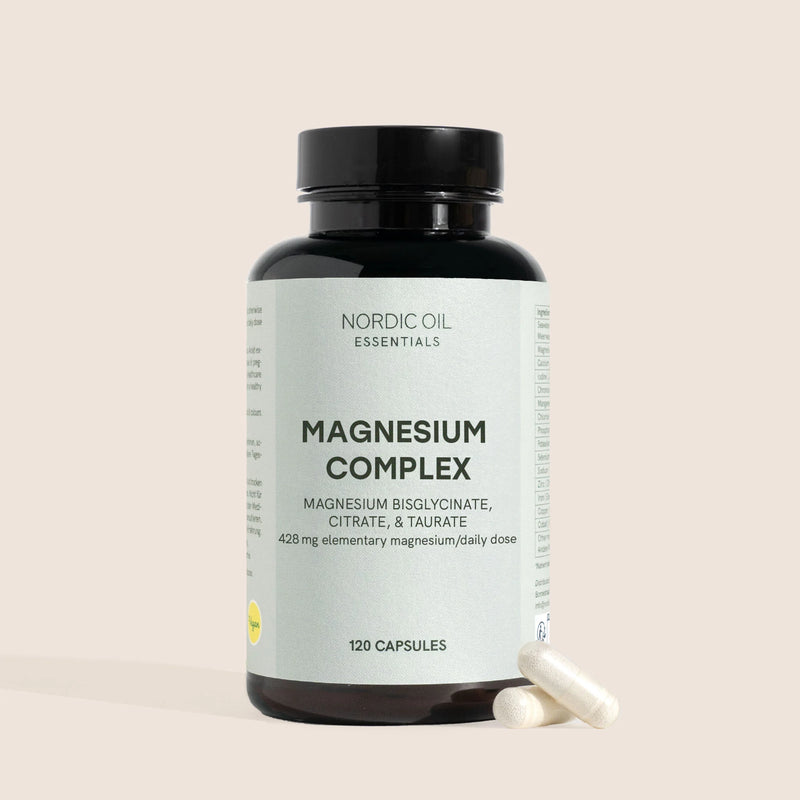 Botella de Nordic Oil Essentials Magnesium Complex con dos cápsulas a su lado.